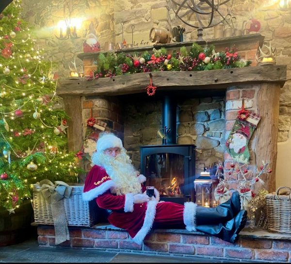 Santa sitting by the fir place